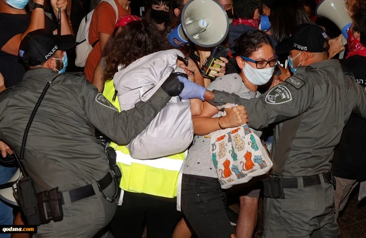 A protester being detained during a demonstration against Prime Minister Benjamin Netanyahu in Tel Aviv