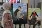 Visitors view artworks made by Palestinian children during exhibition in Gaza City