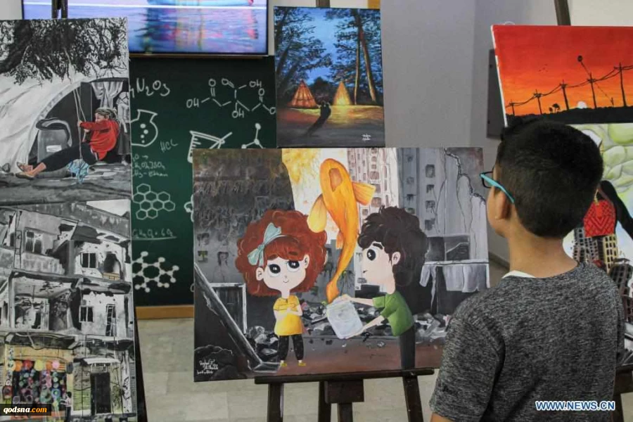 Visitors view artworks made by Palestinian children during exhibition in Gaza City
 3