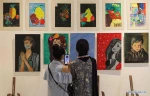 Visitors view artworks made by Palestinian children during exhibition in Gaza City
 2