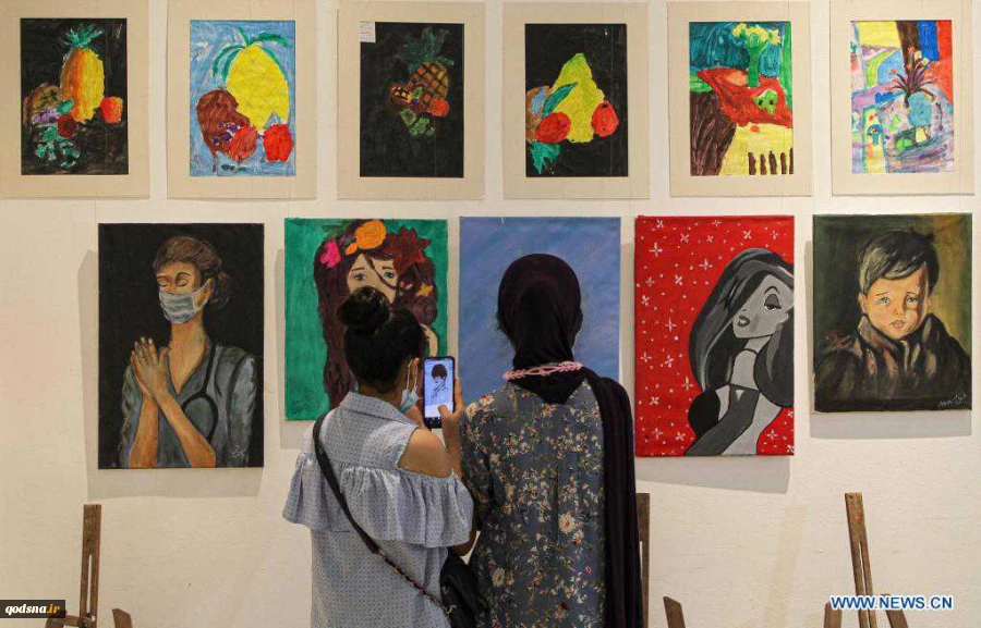 Visitors view artworks made by Palestinian children during exhibition in Gaza City
 2