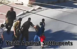Video: Israeli trooper hits Palestinian child